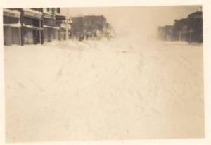 Taken on 4th st, North side, ? market, McBride's, Perry's Hardware, Patten Printing, then 12th ave, then big building in the snow fog, is Quist's store 